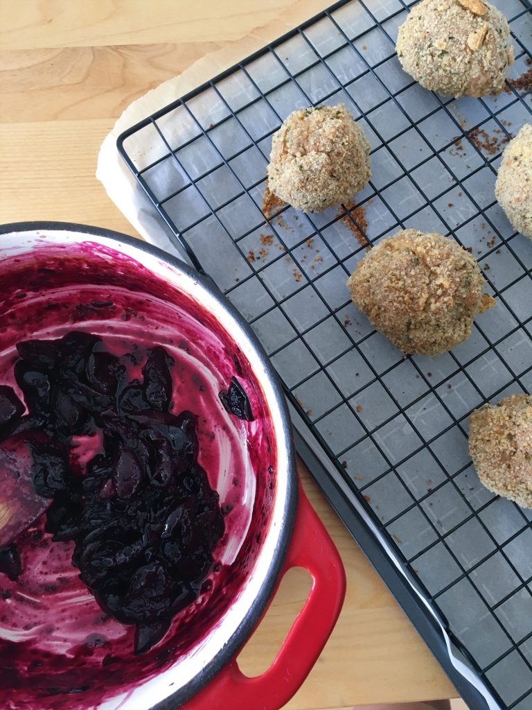 Sauteed cherries in a  le creuset dutch oven for a turkey meatballs dipping sauce