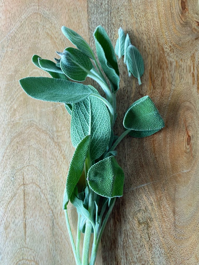 sage on a cutting board for miso braised turkey and kale